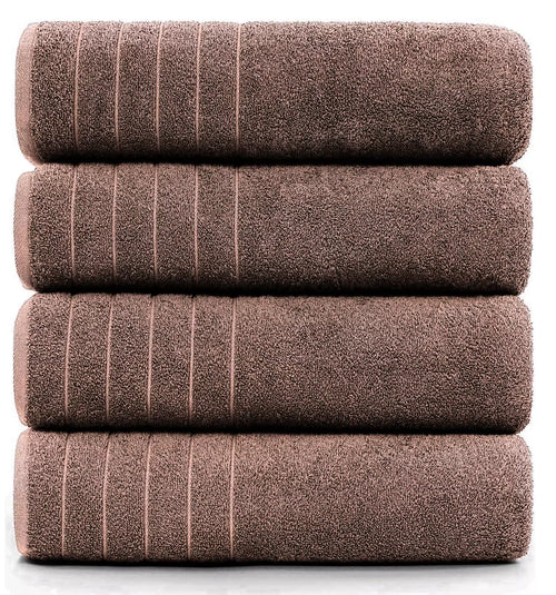 Premium cotton bath sheet used as a beach towel on sandy shore